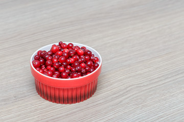 organic cranberries on a wooden table with berries