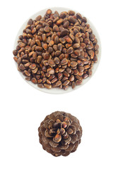 pine nuts and pine cone on wooden table