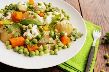 Potato salad with carrots, peas and coriander