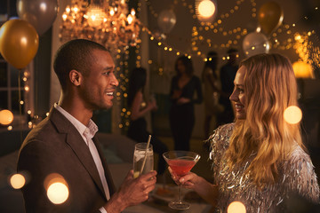 Couple Chat As They Enjoy Cocktail Party Together