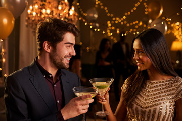 Couple Make Toast As They Celebrate At Party Together