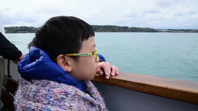 Young happy asian boy on the ship