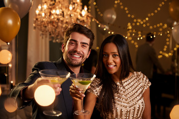 Couple Make Toast At Camera As They Celebrate At Party