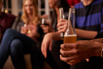 Close Up Of Friends With Drinks Enjoying House Party