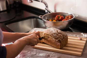 Crop female cutting bread