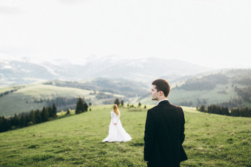 Beautiful bride and groom at the mountains