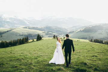 Beautiful bride and groom at the mountains