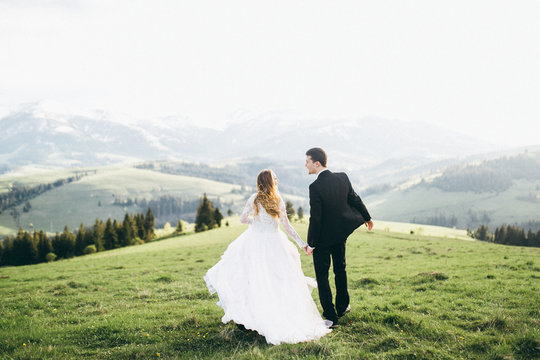 Beautiful bride and groom at the mountains