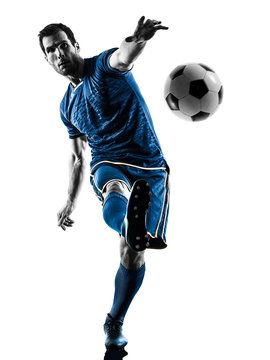 Fototapeta one caucasian soccer player man playing kicking in silhouette isolated on white background