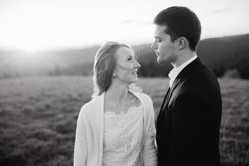 Wedding couple are looking to the sunset