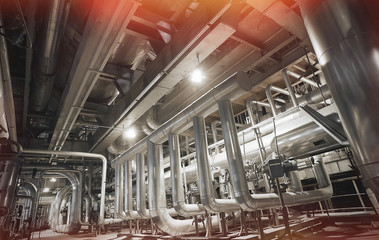 Equipment, cables and piping as found inside of a modern industrial power plant