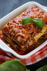 Close-up of italian traditional lasagna bolognese, vertical shot, selective focus