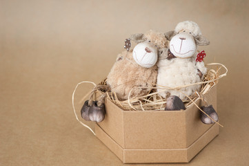 souvenir toy lamb in a cardboard box on a brown background