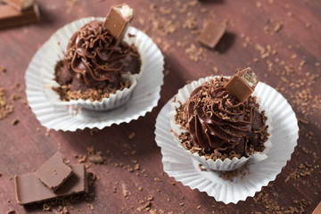 Chocolate cupcakes on white plate, homemade bakery, selective focus, close up