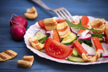 Vegetable salad of crab sticks and crackers