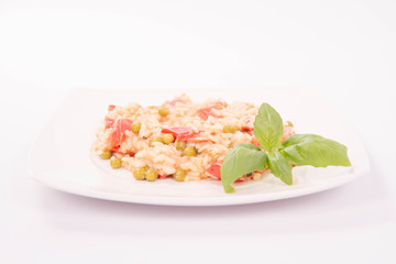 Risotto with tomato and pea on a white background