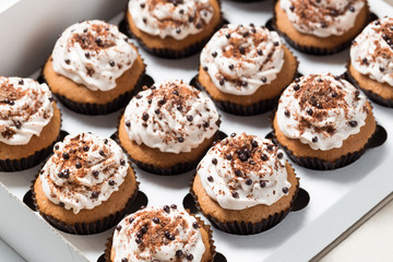 Delivery box: coffee cupcakes with mocha butter cream and chocolate decorations