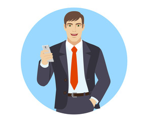 Businessman with mobile phone standing with hand in pocket