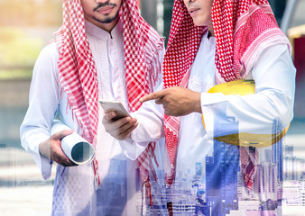arab businessman engineer holding smart phone, business engineering concept, city background, double exposure.