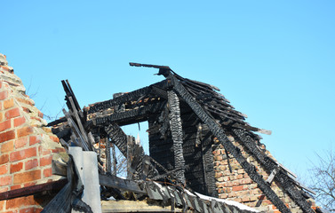 Fototapeta na wymiar Brick House Roof Fire Damage. Old Home Burns Down.