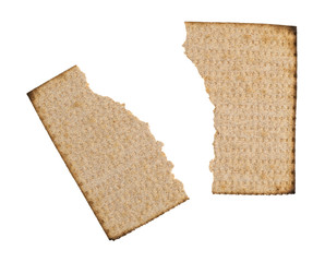 Broken whole wheat matzo cracker isolated on a white background.