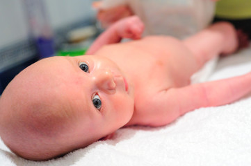 Mom puts a diaper on the baby