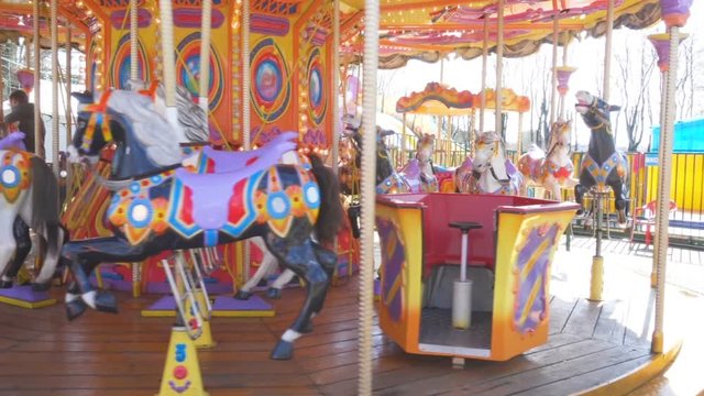 Merry-go-round with horses. Old French carousel in a holiday park. Horses and animal  on a traditional fairground vintage carousel.