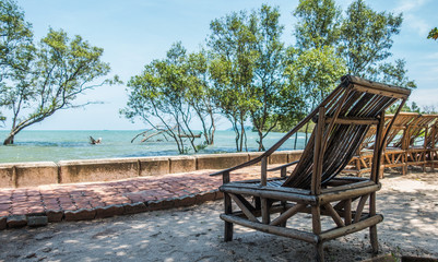 Obraz premium bamboo chair facing sea