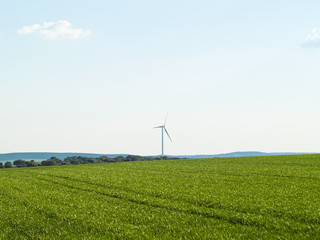 Fototapeta na wymiar Windmill on countryside generating wind energy