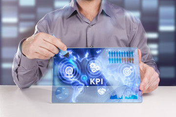 Business, Technology, Internet and network concept. Young businessman working on a virtual screen of the future and sees the inscription: KPI