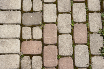 Metal grille against the wall, stone path, old paint