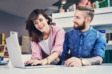 Happy designers working together on laptop