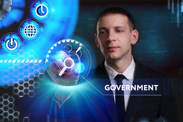 Business, Technology, Internet and network concept. Young businessman working on a virtual screen of the future and sees the inscription: Government