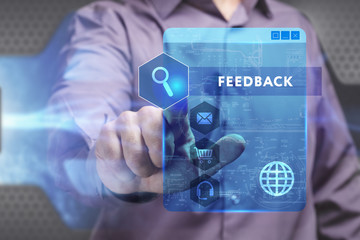 Business, Technology, Internet and network concept. Young businessman working on a virtual screen of the future and sees the inscription: Feedback