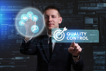Business, Technology, Internet and network concept. Young businessman working on a virtual screen of the future and sees the inscription: Quality control