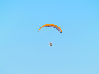 A man practicing extreme sport with paraglider with motor