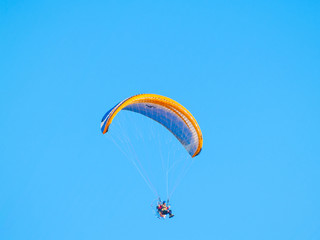 A man practicing extreme sport with paraglider with motor