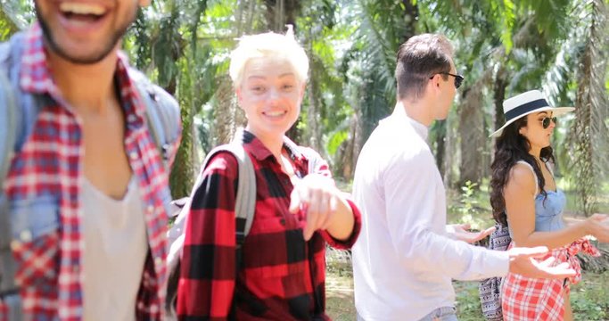 People Group With Backpacks Trekking On Forest Path, Young Men And Woman On Hike In Tropical Palm Tree Park Tourists Slow Motion 60