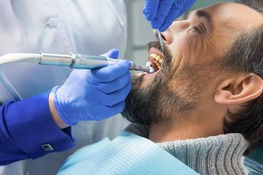 Dentist Cleaning Teeth. Hands Of Stomatologist With Tools. Dental Health Services.