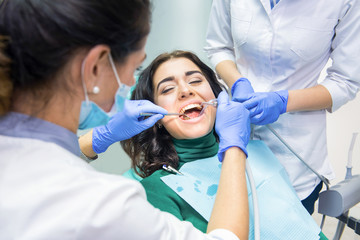 Woman at the dentist office. Dental doctors at workplace. Trust health to best professionals.