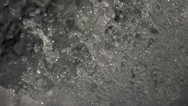 Super slow motion water floating down a cascade of a river, close, in HD