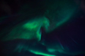 Fototapeta premium The polar Northern lights in the mountains of Svalbard, Longyearbyen, Spitsbergen, Norway wallpaper