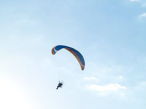 A Man Practicing Extreme Sport With Paraglider With Motor