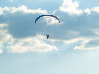 A man practicing extreme sport with paraglider with motor