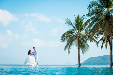 Newly married couple after wedding in luxury resort. Romantic bride and groom relaxing near...