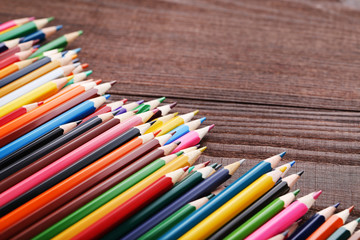 Fototapeta premium Drawing colourful pencils on brown wooden table