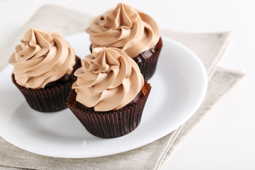 Tasty cupcakes on a white wooden table