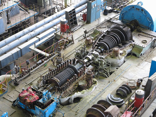Fototapeta steam turbine in repair process, machinery, pipes, tubes, at power plant obraz