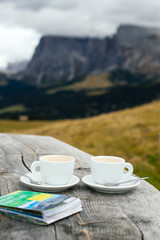 Romantic breakfast with coffee for two persons on the background of the rocky mountains in the Dolomite, Italy