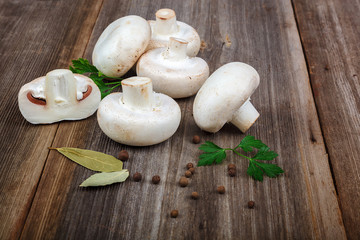 Mushrooms, spices on the wooden background